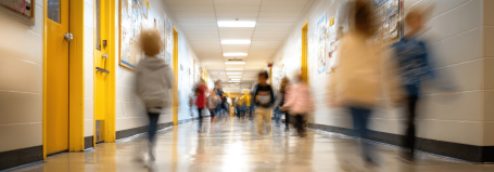 School children holding hands in a corridor during an emergency lockdown procedure drill