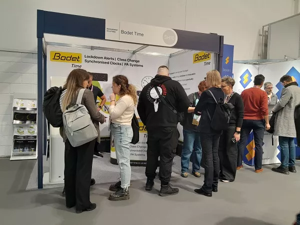 Images show visitors to the Bodet Time stand at the Bett Show 2025, discussing time and alert solutions with the Bodet Time team